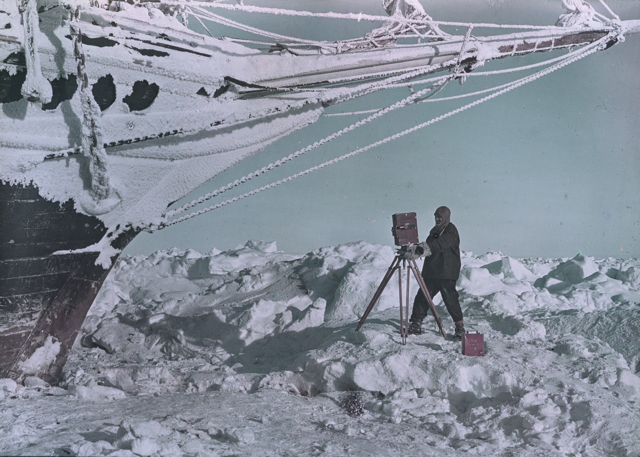 Frank Hurley takes photographs of the Endurance beset in the ice.